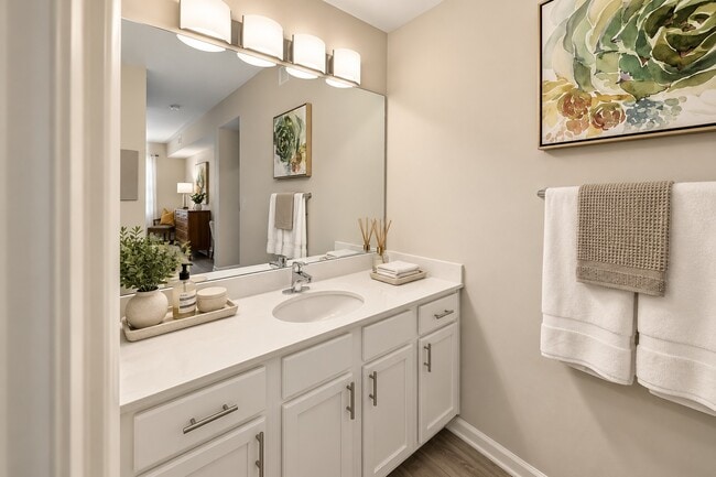Step into the elegance of Delray Bay's bathroom, featuring a sleek double vanity and modern fixtures. Bright and spacious, this haven epitomizes comfort and style. Explore your future home today!
