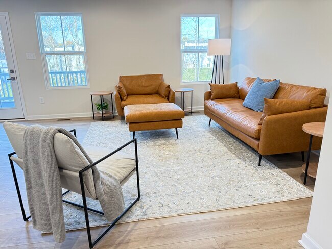 Bright and beautiful great room. Albany Park leather sofa and chair.