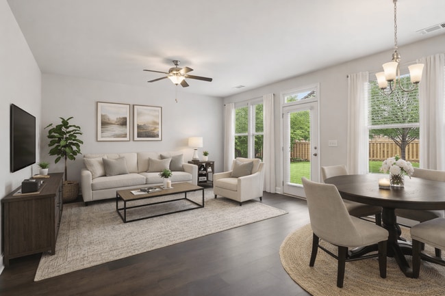 Living room with large window letting in a ton of natural light. - Chase Landing