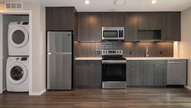 Kitchen with Stainless Steel Appliances and In-home Washer and Dryer