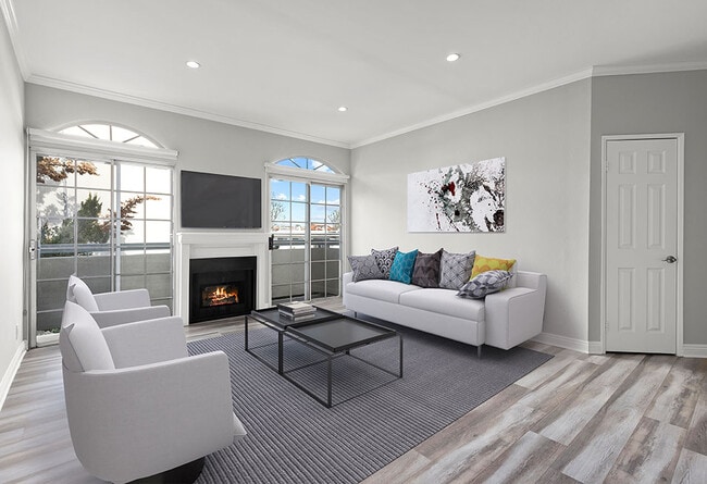 Large living room featuring hardwood floors and natural light providing adjacent patio. - Chateau Encino Rental