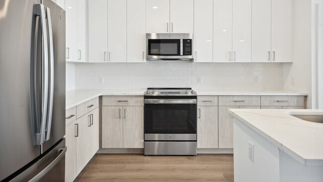Kitchen with Stainless Steel Appliances and White Granite Countertops