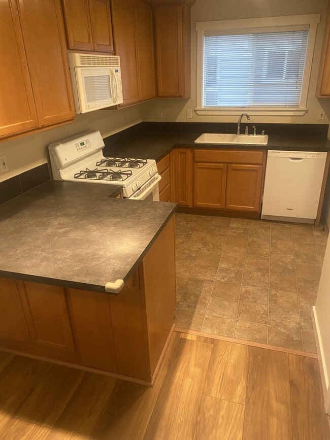Photo - LIKE NEW three bedroom with fantastic updates, one car garage and private newly fenced front patio!