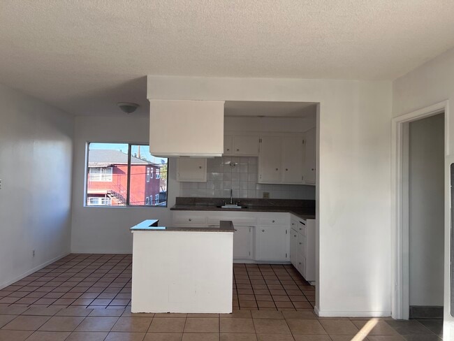 Kitchen view from living room - 8129 Otis St Unit Apt. E