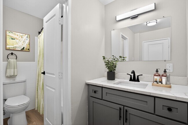 Elevate your living standards at Merrill House Apartments, where modern design meets comfort. This beautifully designed bathroom features elegant fixtures and ample lighting, perfect for your daily routine. Schedule a tour today!