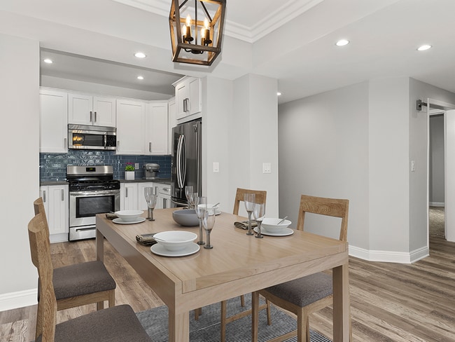 Hardwood floored dining room with view of kitchen.