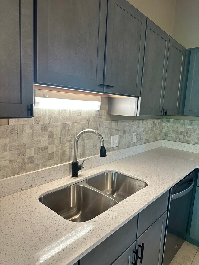 Lots of countertop space. New fixtures, sink and backsplash - 8020 Zane Ave N