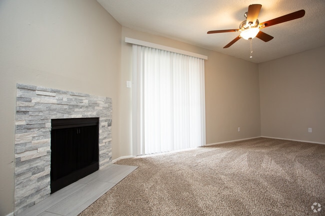 1BR, 1BA - 682SF Living Room With Fireplace and Balcony - Victoria Station Apartments