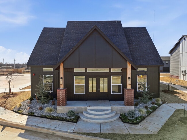 Charming modern club house/leasing office with stylish architecture, elegant brick accents, and inviting landscaped entrance.