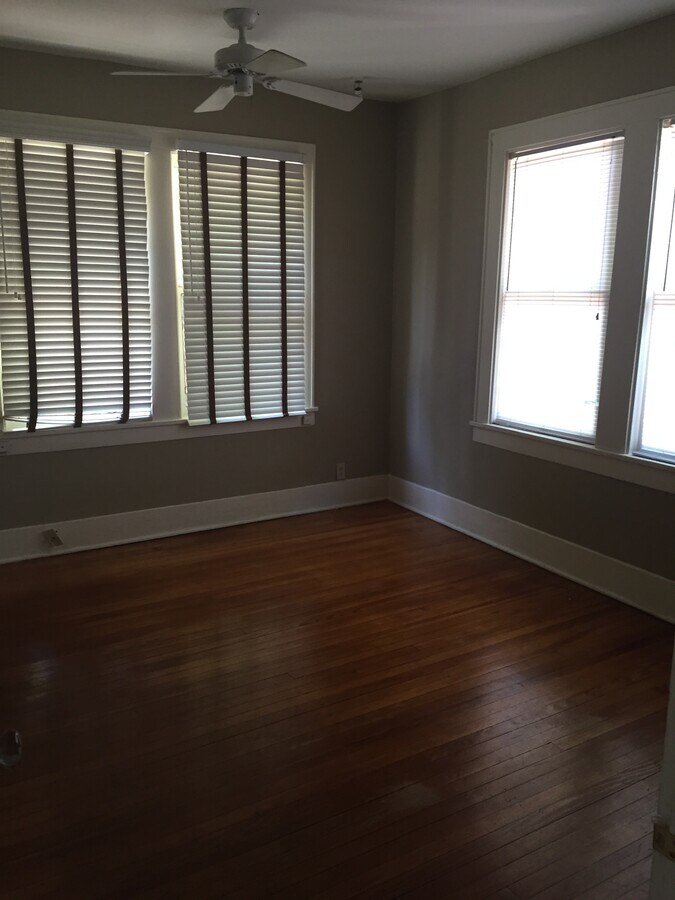 Large bedroom with wood floors, closet, and plenty of windows - 1926 Harold St