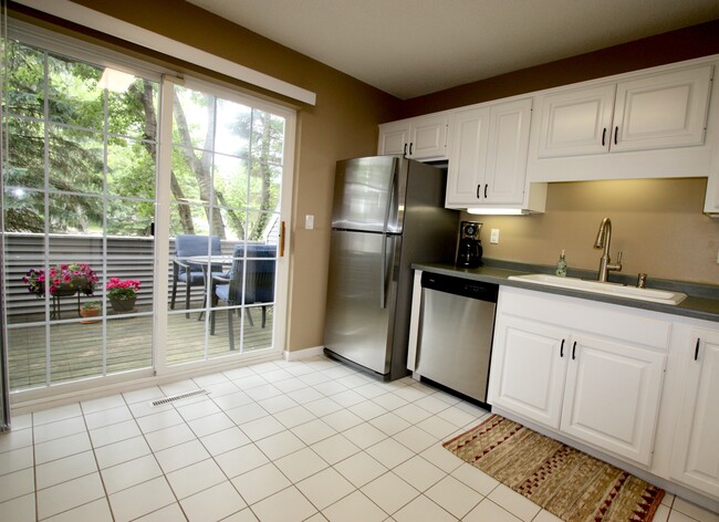 Bright kitchen that walks out to the side patio. - 15805 24th Ave N. Unit A