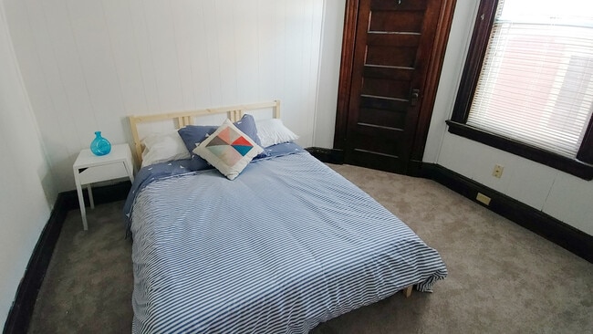 Bedroom with double bed and small closet. - 1922 Bigelow St Unit Apt 2
