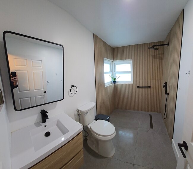 “Modern bathroom with walk-in shower and updated finishes” - 14653 SW 145th Ter