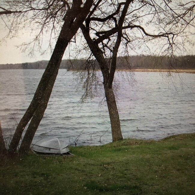 Holt Lake with small fishing boat in front of cabin. - 26437 Linden street House
