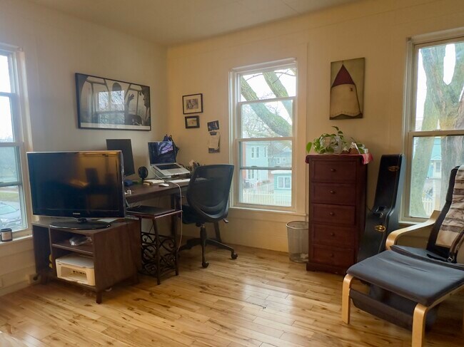 Corner of the living/dining room, looking out towards Monore Street. - 25 Monroe St Unit 1