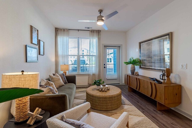 Spacious and move-in ready, the living area offers room to lounge and entertain, with a ceiling fan and wood-style plank flooring throughout.