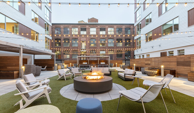 Your new home includes a large central social area with firepits, fitness center, and co-working spaces. - Prism Apartments