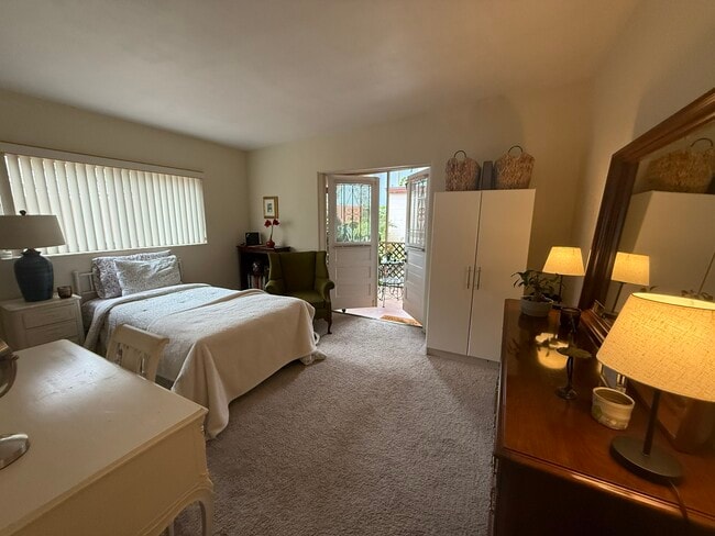 Large master bedroom, French doors open to screened porch