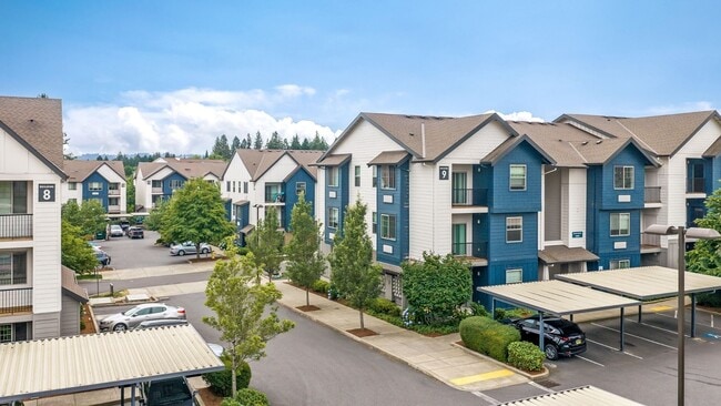 Contem porary apartme nt buildings with landscaped grounds and covered resident parking - Victory Flats at Elmonica Station Apartments