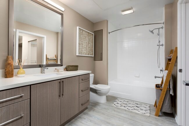 Design Scheme II bath with quartz countertops, new cabinets, and hard surface plank flooring