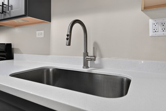 Enjoy modern finishes like this sleek chrome faucet and sink at Renaissance at Carol Stream in Carol Stream, IL. - Renaissance at Carol Stream
