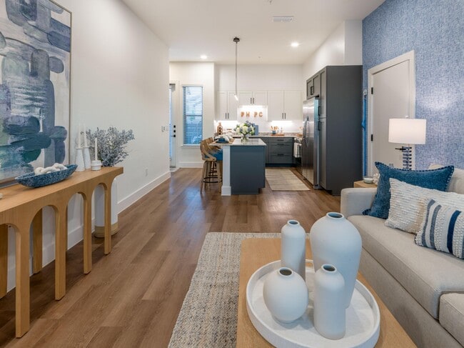 Living room with open spaces looking into the kitchen