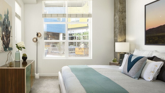 Spacious apartment bedroom with carpeted floors. - Griffis Union Station