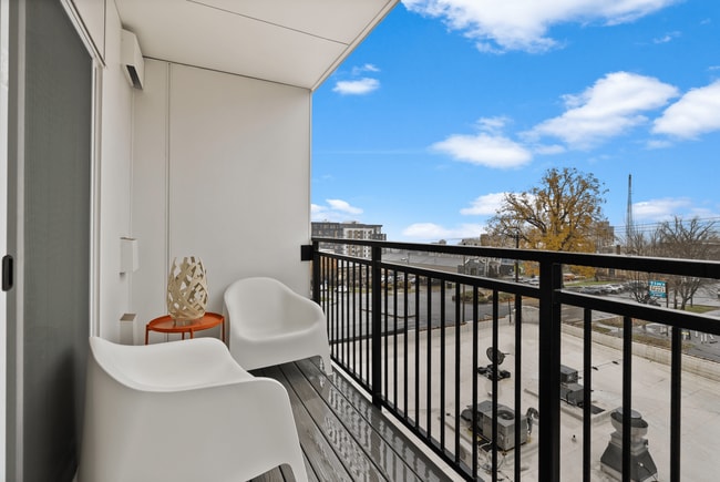 Step outside and enjoy fresh air and elevated city views from your private balcony.