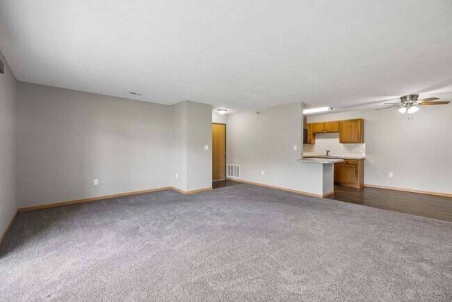 A spacious open floor plan creates a warm, inviting atmosphere with plenty of room to relax, entertain, and make yourself at home. - Williamsburg Park Apartments