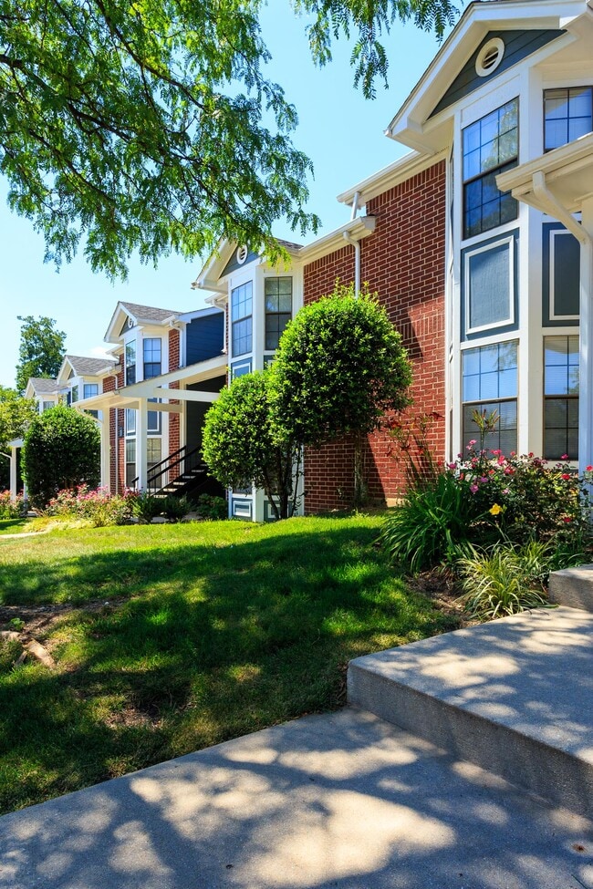 Beautiful Landscaping with Greenery and Flowers - Rolling Brook Village Apartments