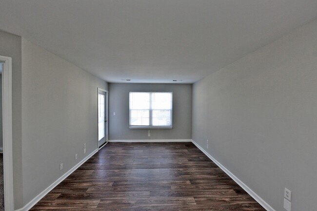 Spacious living room with hardwood-style flooring
