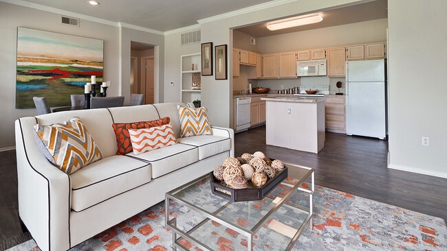 Spacious Living Room and Kitchen with Quartz Countertops, White Appliances, and Island