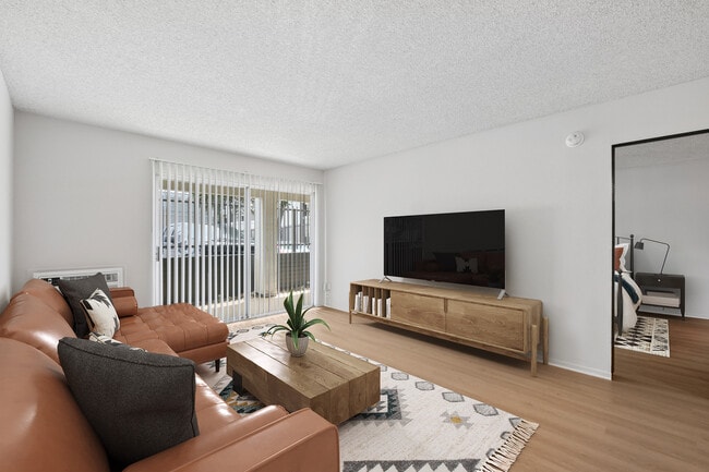 Renovated Package I living room with updated hard surface flooring (select homes)