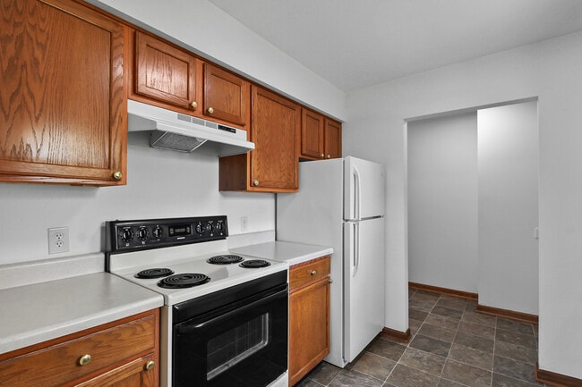 Kitchen with Oven/Range, Fridge, and Entry to Laundry