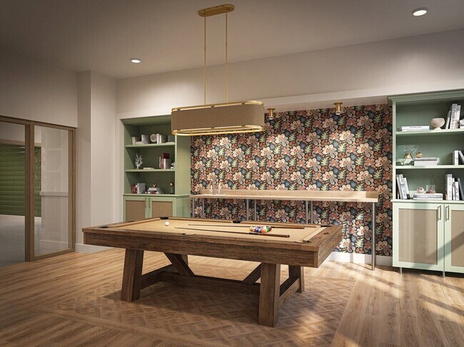 Resident clubroom with a pool table, modern finishes, and gathering space.