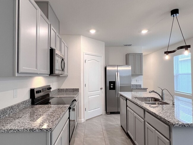 Photo - Four-Bedroom Home with Modern Finishes & Open Layout