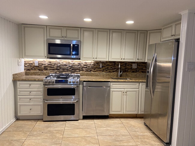 Kitchen with Dishwasher, Stove, Microwave, Stainless Fridge - 112 3rd St NE Unit Basement