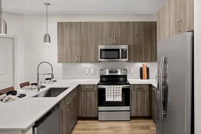 Welcoming Kitchen witth Stainless Steel Appliance Package - Serenza at Ocoee Village Apartments