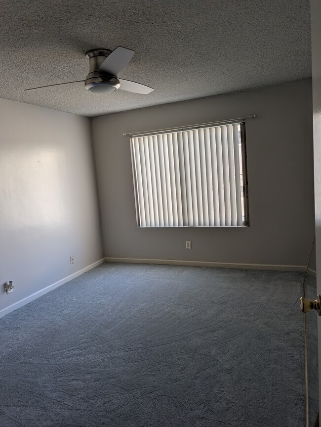 Bedroom with new carpet and fan