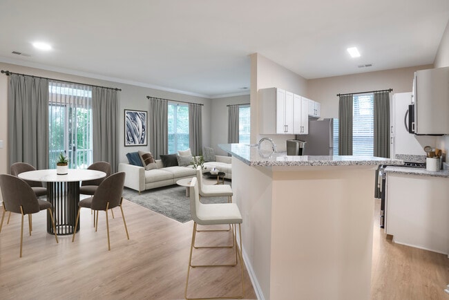 Renovated Package II kitchen and living room with hard surface flooring - Avalon at Traville