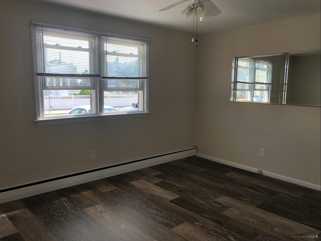Living Area Showing Example of New LVP Flooring (Photo of downstairs unit with same layout) - 109 W Brigantine Ave Unit 6