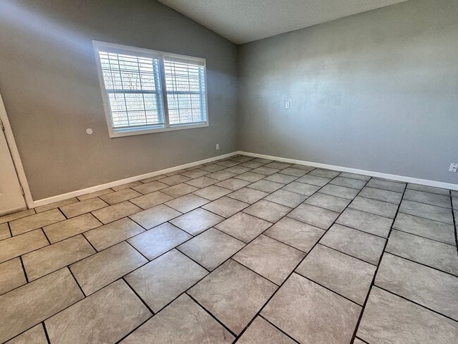 Photo - Charming 3-bedroom, 1-bath home featuring an attached carport and a fully fenced backyard—perfect...