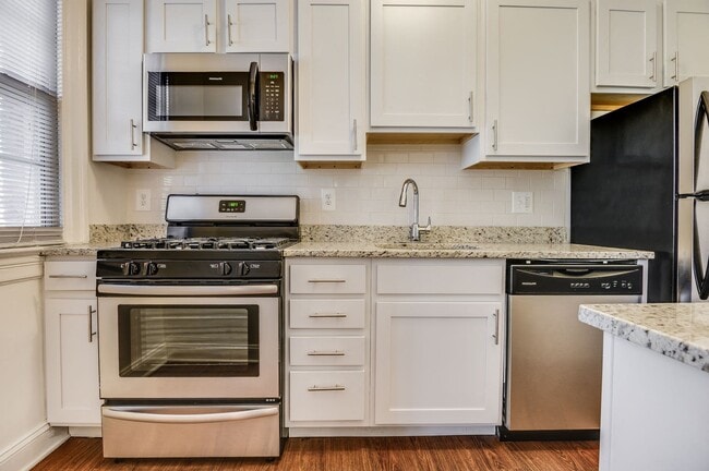 Renovated kitchen with stainless steel appliances and granite countertops