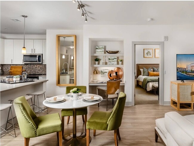 A built-in shelf niche sits between the dining area and the bedroom door.