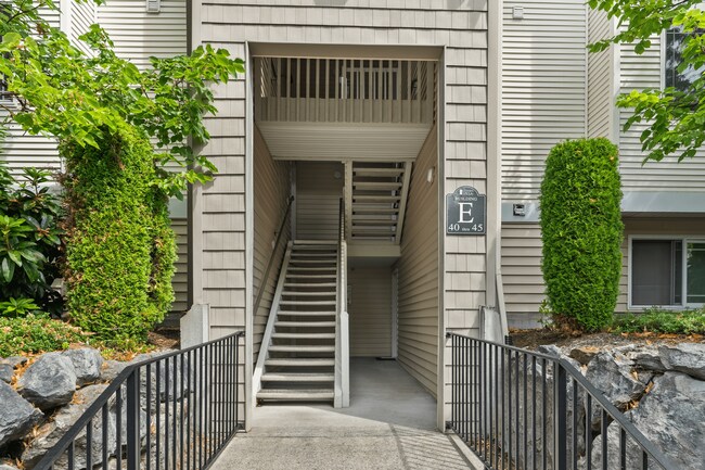 Convenient stairwell access at Building E with well-maintained surroundings. - Garden Villa Apartments