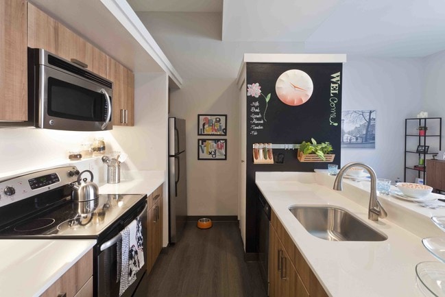 State-of-the-art kitchens with stainless appliances and quartz countertops