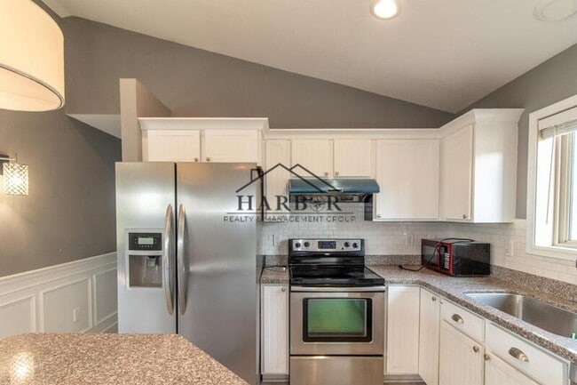 Building Photo - Updated 4 Bedroom Home with Remodeled Kitchen & Tiered Deck