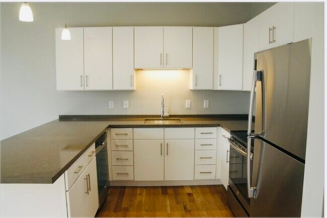 White cabinets, stone counters, stainless-steel appliances - 20 Orleans St Unit 302
