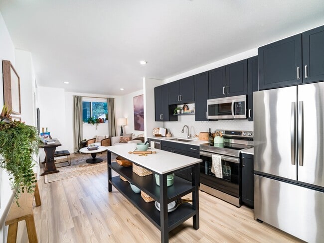 An open kitchen with a central island at Modera University Park, offering multiple finish options to choose from.