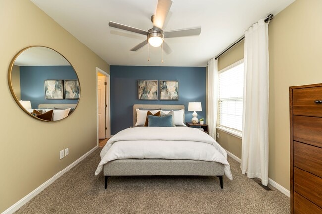 Cozy bedroom with carpet and ceiling fan